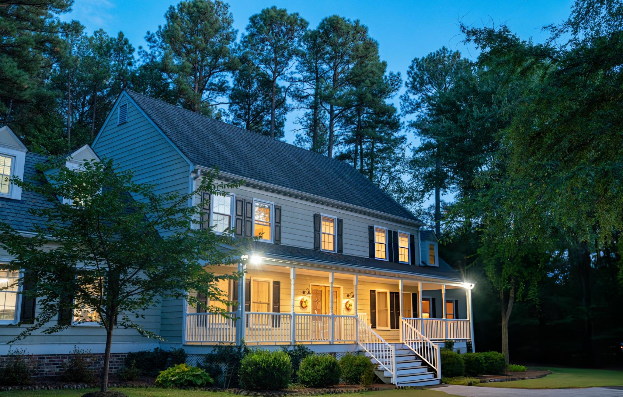 A home terns it's light on, from a nice outside view in the evening 